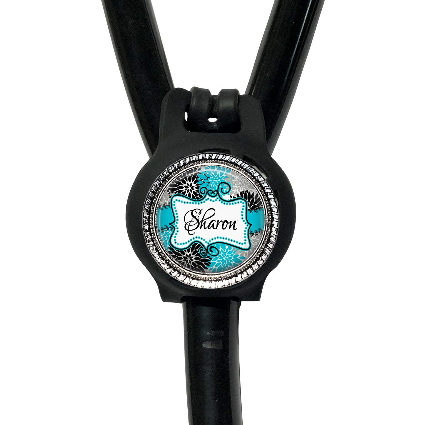 A black stethoscope with a round, personalized name tag attached to it.
