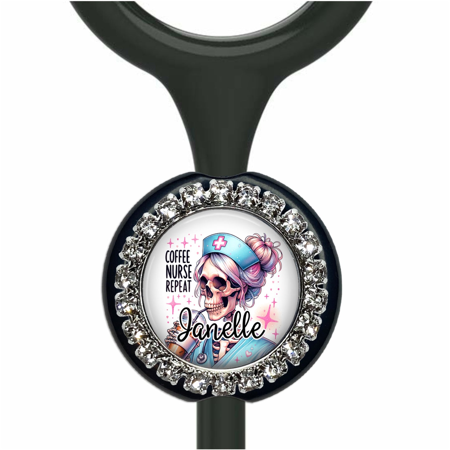 A black stethoscope with a round charm featuring a cartoon image of a skeleton wearing a nurse's hat and the text "Coffee Nurse Repeat Janelle".