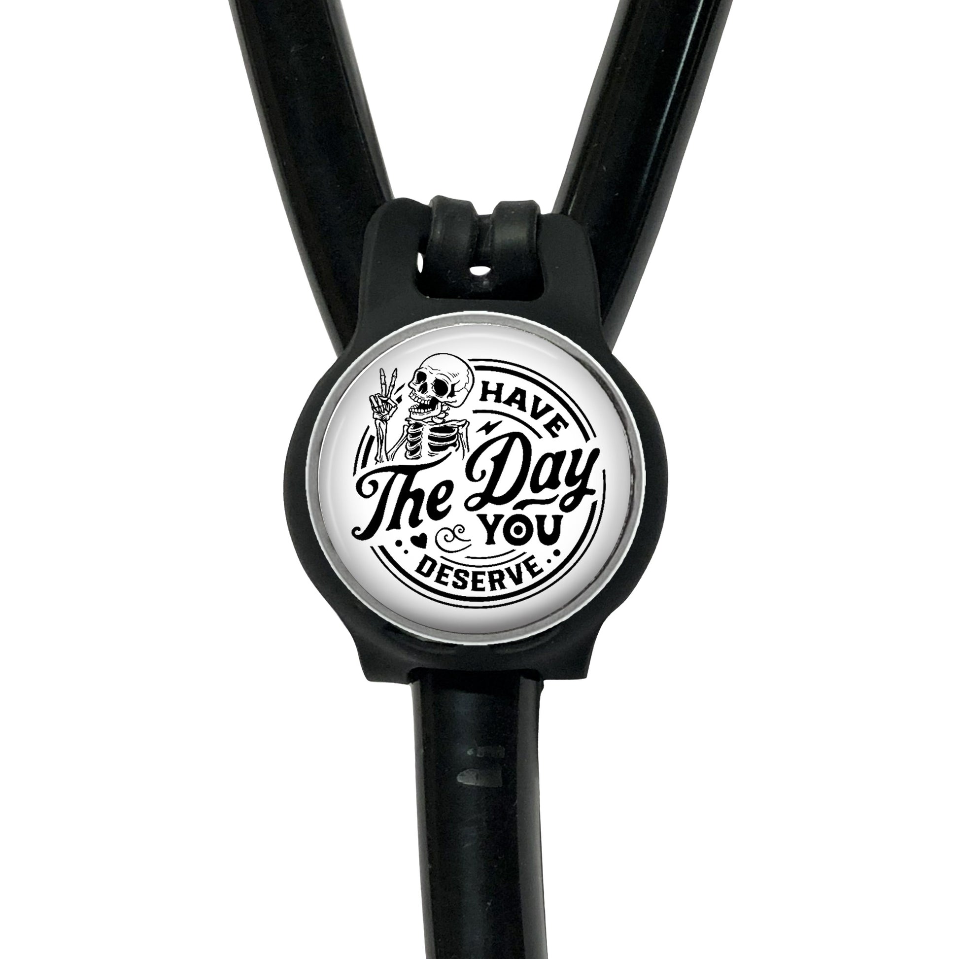 A black stethoscope with a circular badge featuring a skeleton and the text "The Day You Serve".