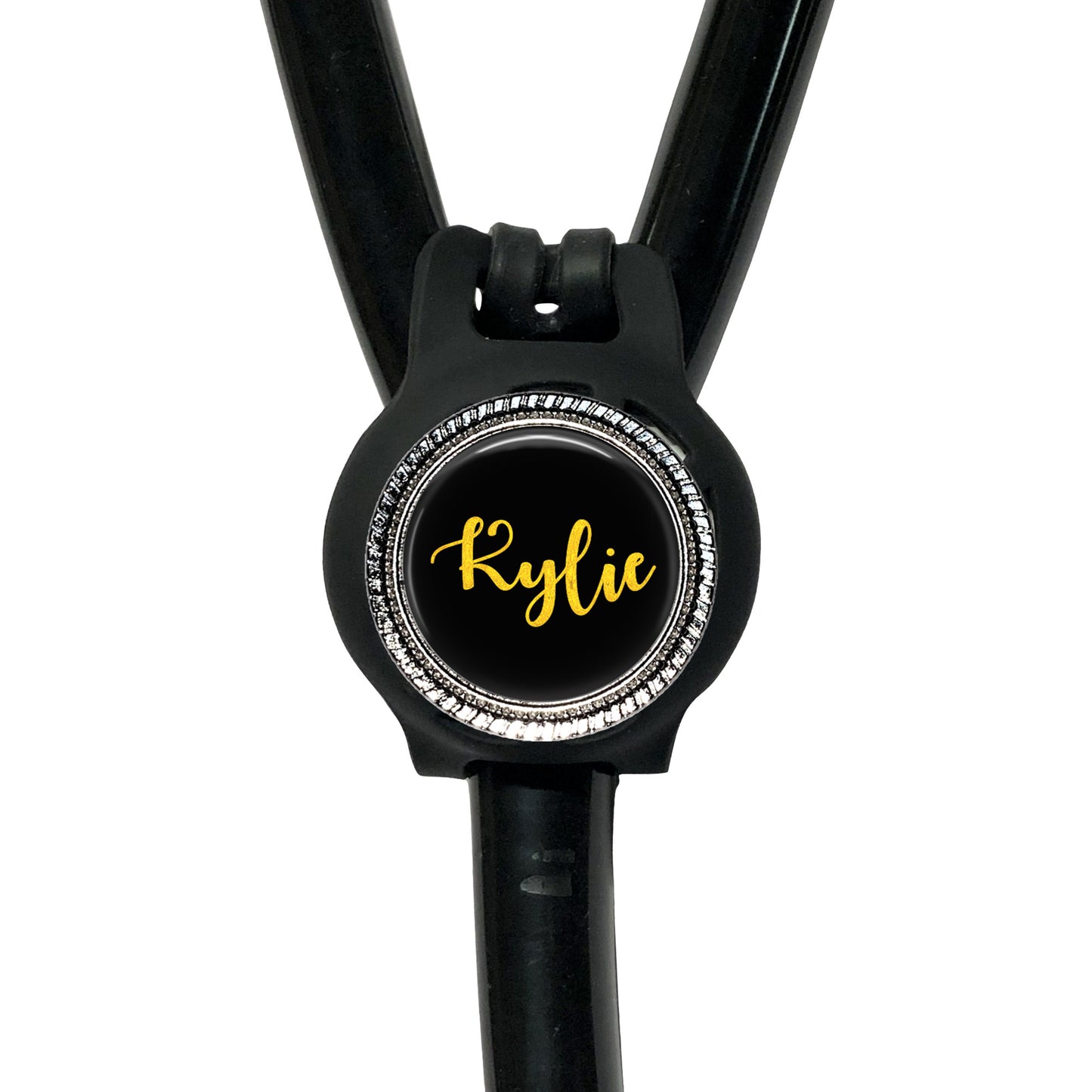 A black stethoscope with a personalized name badge attached to it.