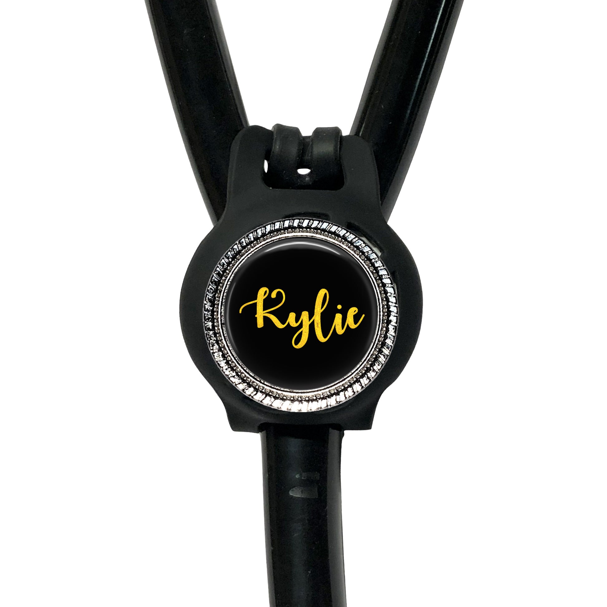 A black stethoscope with a personalized name badge attached to it.