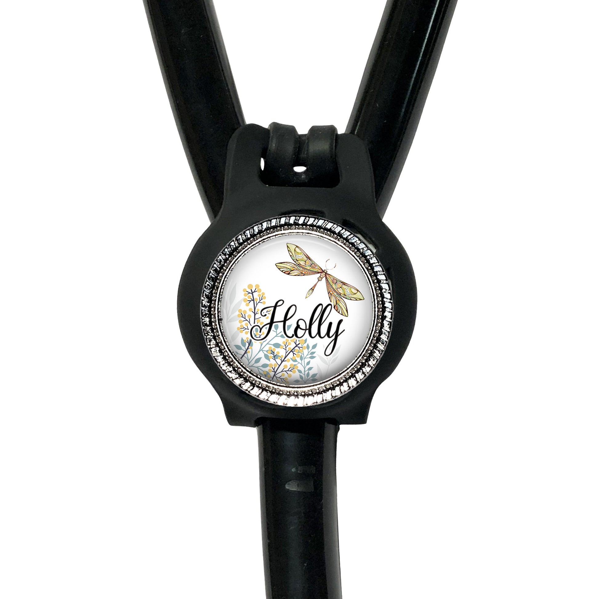A black stethoscope with a round, decorative badge featuring a dragonfly and the name "Holly" written on it.