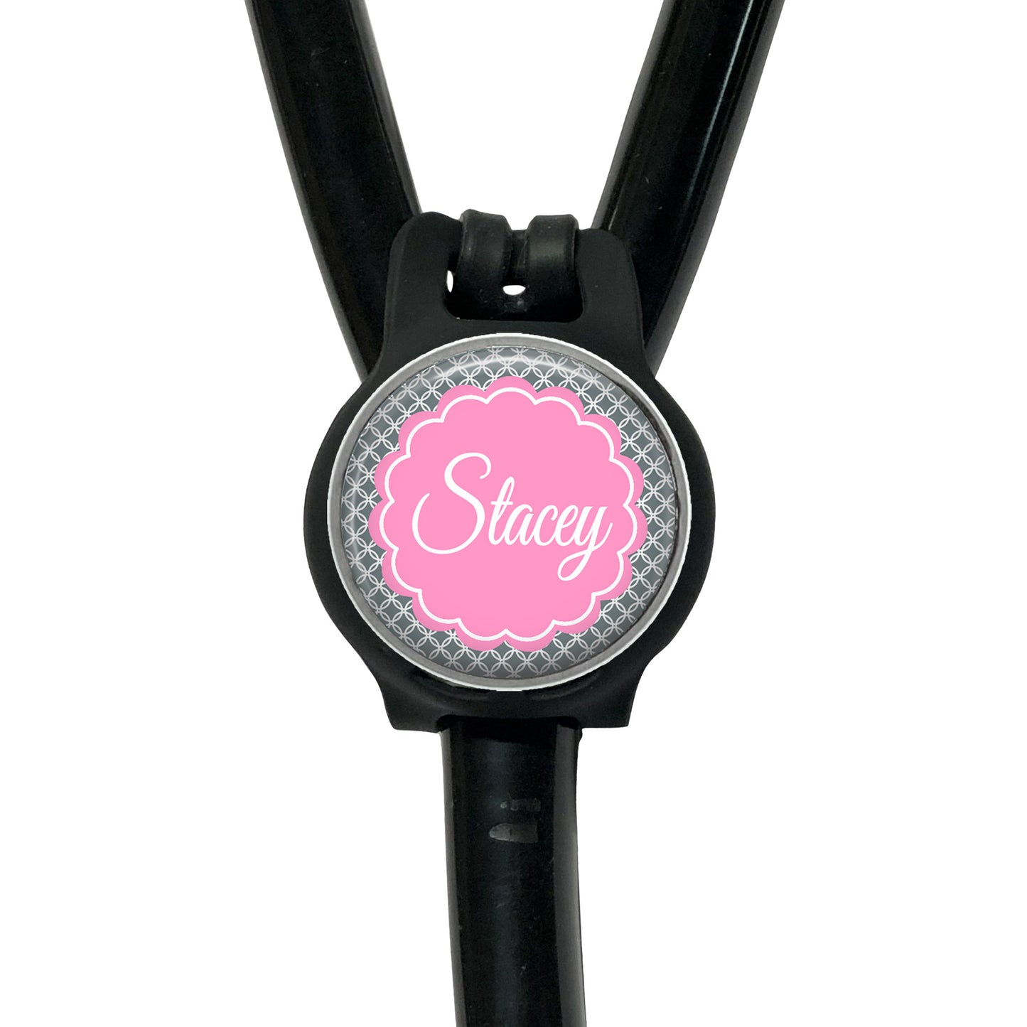A black stethoscope with a personalized name badge attached to it.