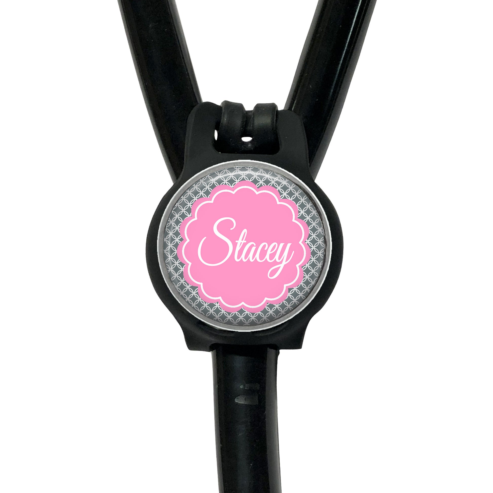 A black stethoscope with a personalized name badge attached to it.