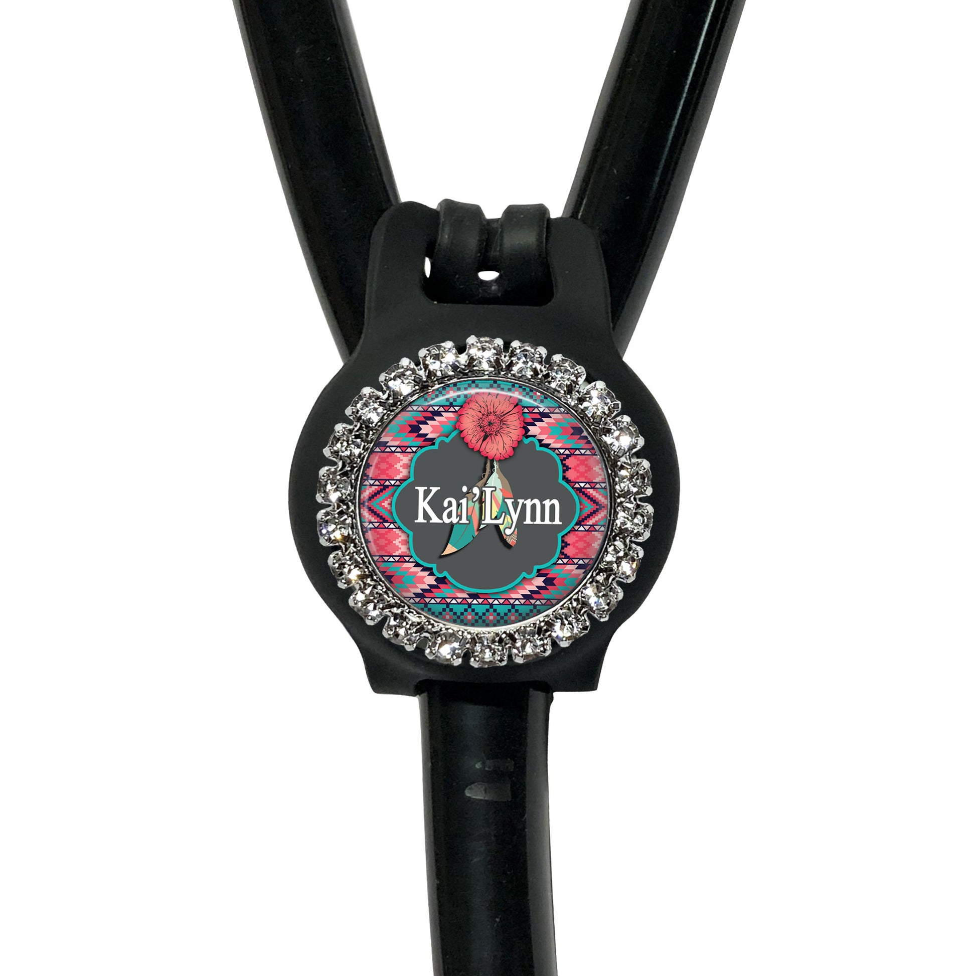 A black stethoscope with a personalized name badge attached to it.