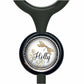 A black stethoscope with a round, decorative charm featuring a dragonfly and floral elements.