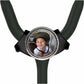 A young boy wearing a helmet is smiling at the camera, with a black stethoscope-style accessory featuring a circular frame with a photo of the boy inside.