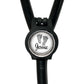 A black stethoscope with a round badge on the front, featuring a pair of footprints and the name " Jessie" written on it.