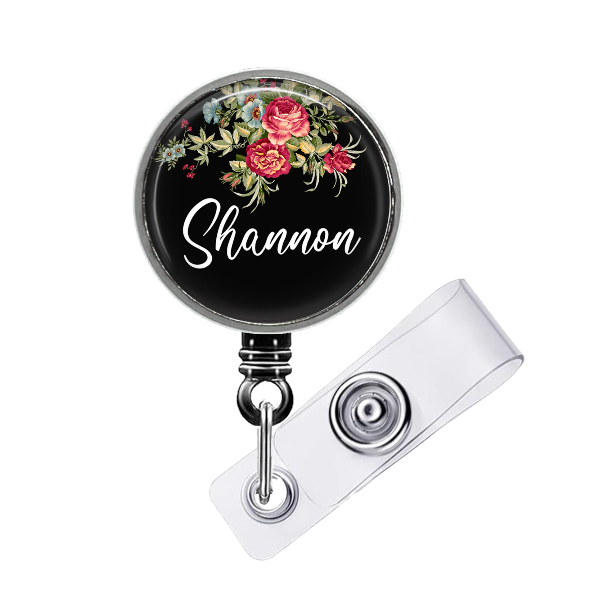 A black badge holder with a floral design and the name "Shannon" written on it.