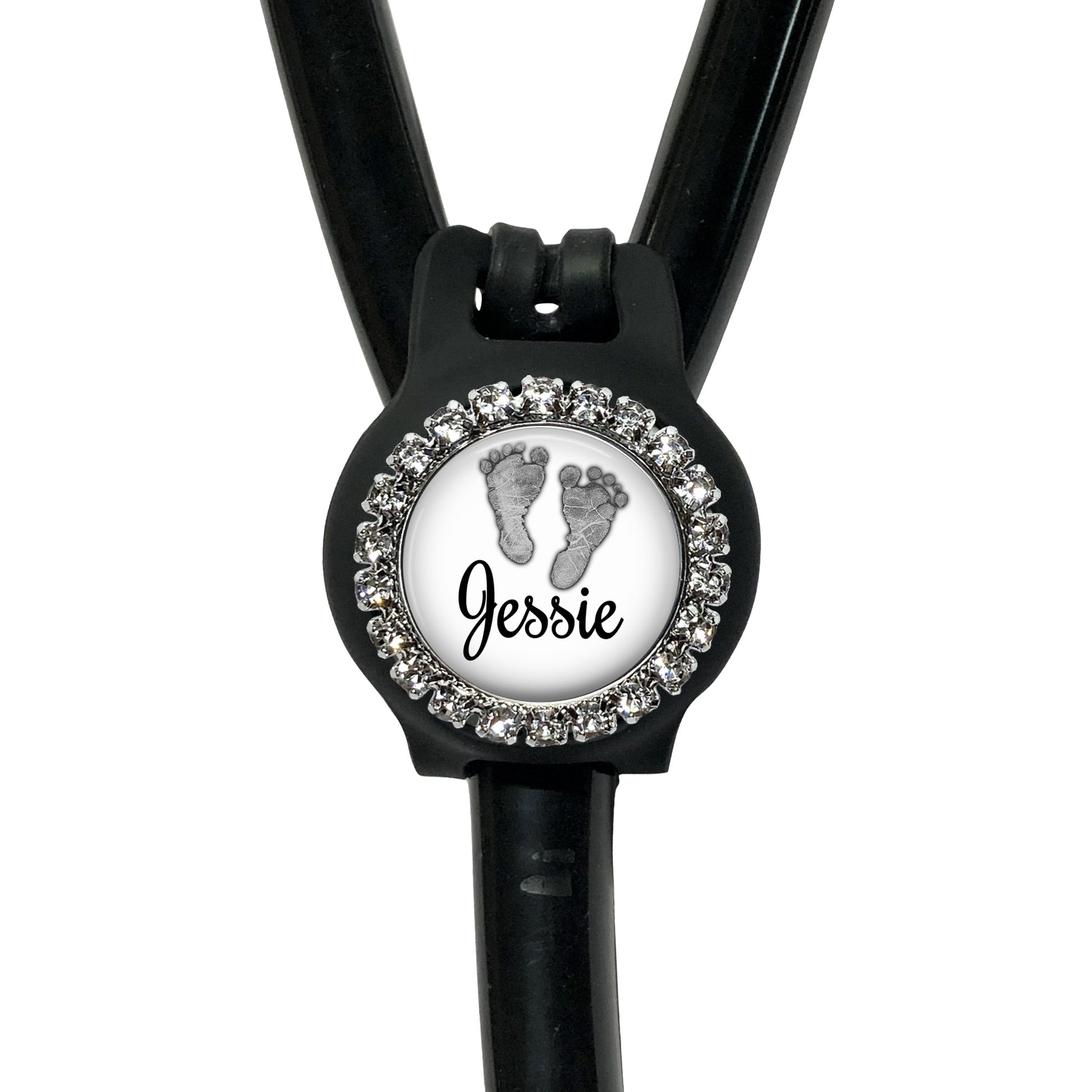 A black stethoscope with a personalized name badge attached to it.