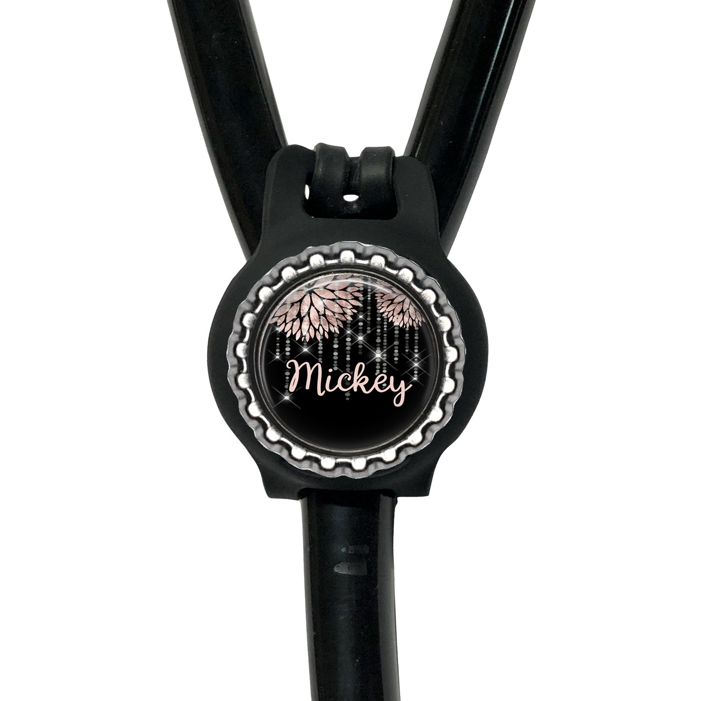 A black stethoscope with a round, personalized name tag attached to it.