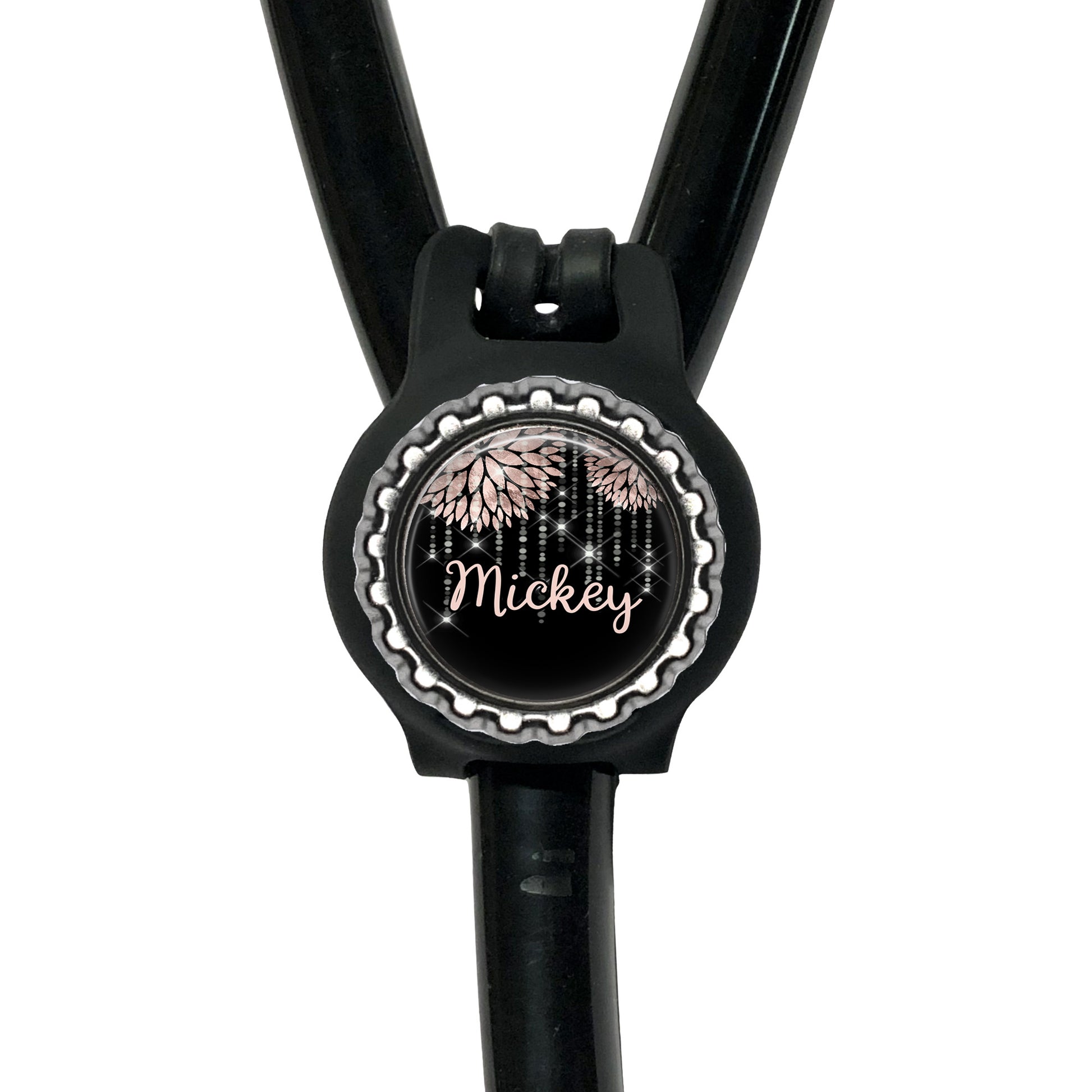 A black stethoscope with a round, personalized name tag attached to it.