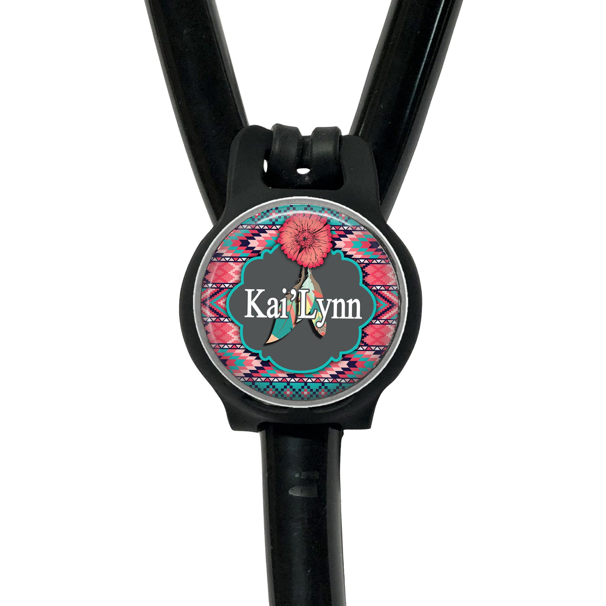 A black stethoscope with a personalized name badge attached to it.
