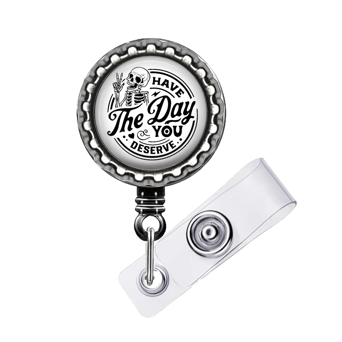 A metal badge holder with a circular design featuring a skeleton and the text "The Day & You Deserve".