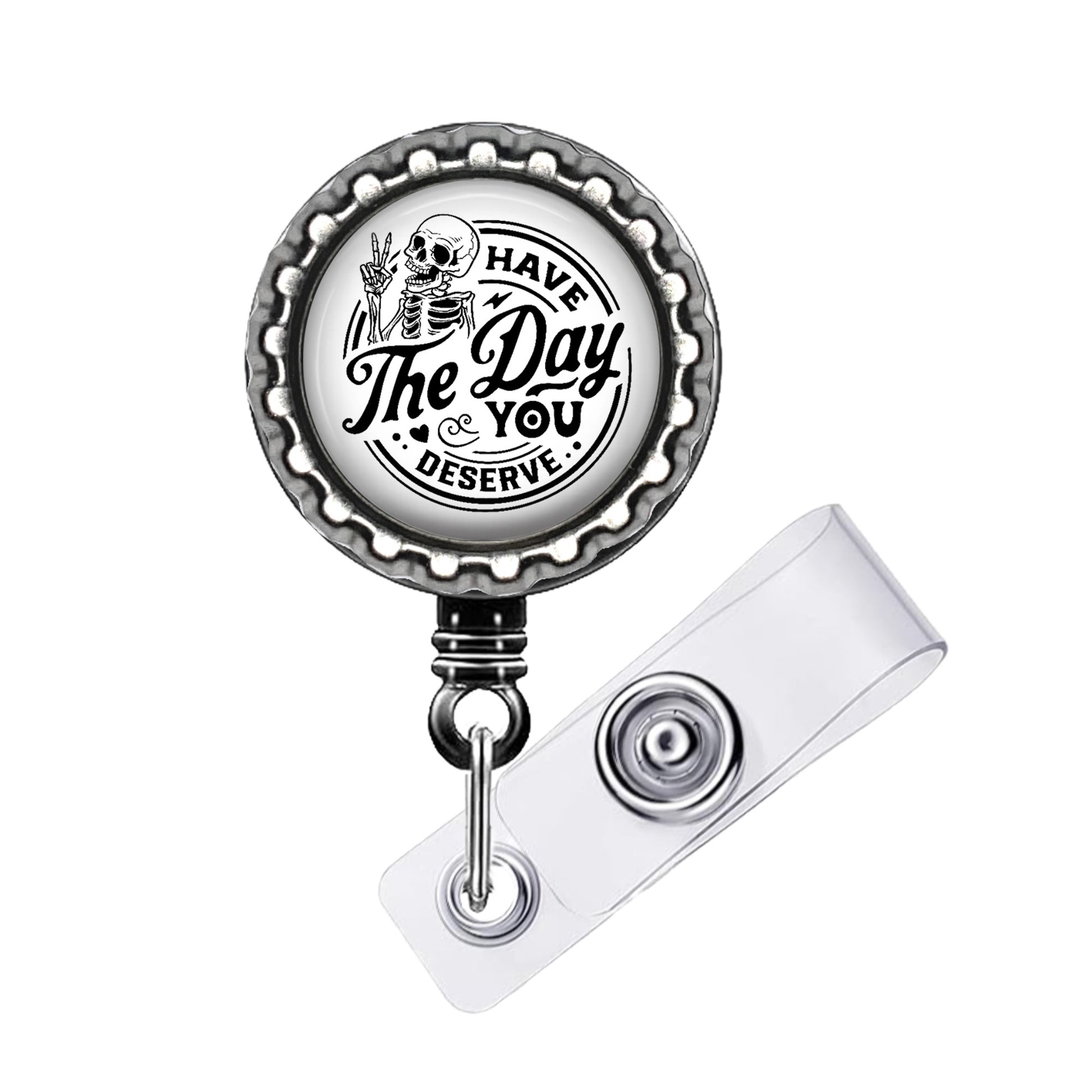 A metal badge holder with a circular design featuring a skeleton and the text "The Day & You Deserve".