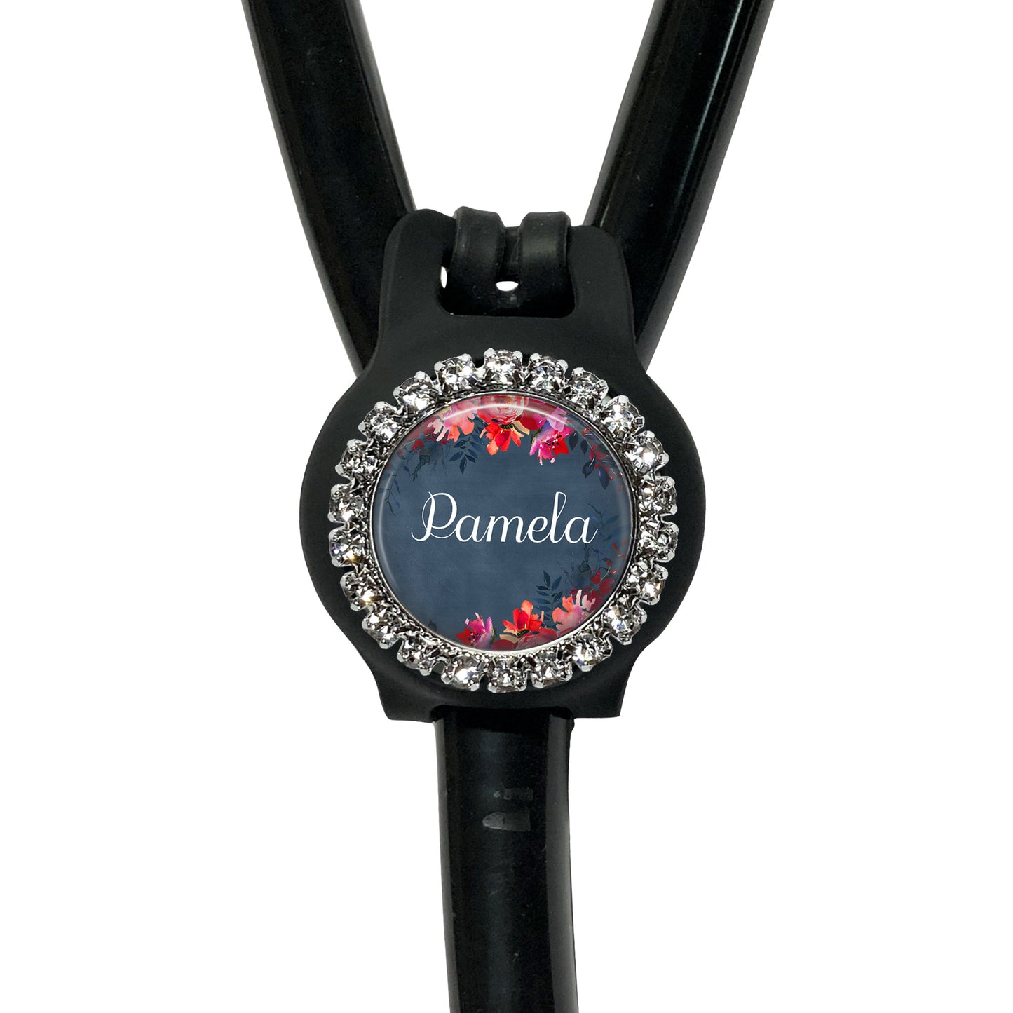 A black stethoscope with a personalized name badge attached to it.