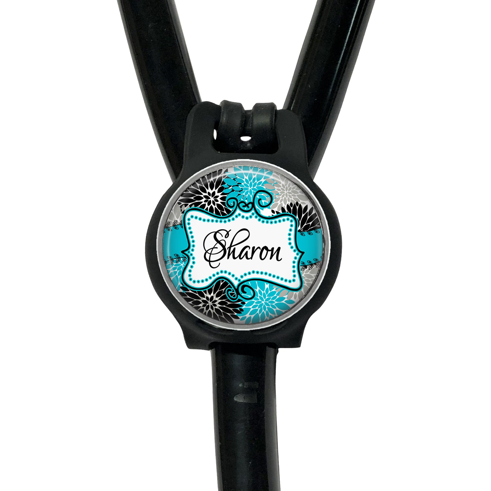 A black stethoscope with a round, personalized name tag attached to it.
