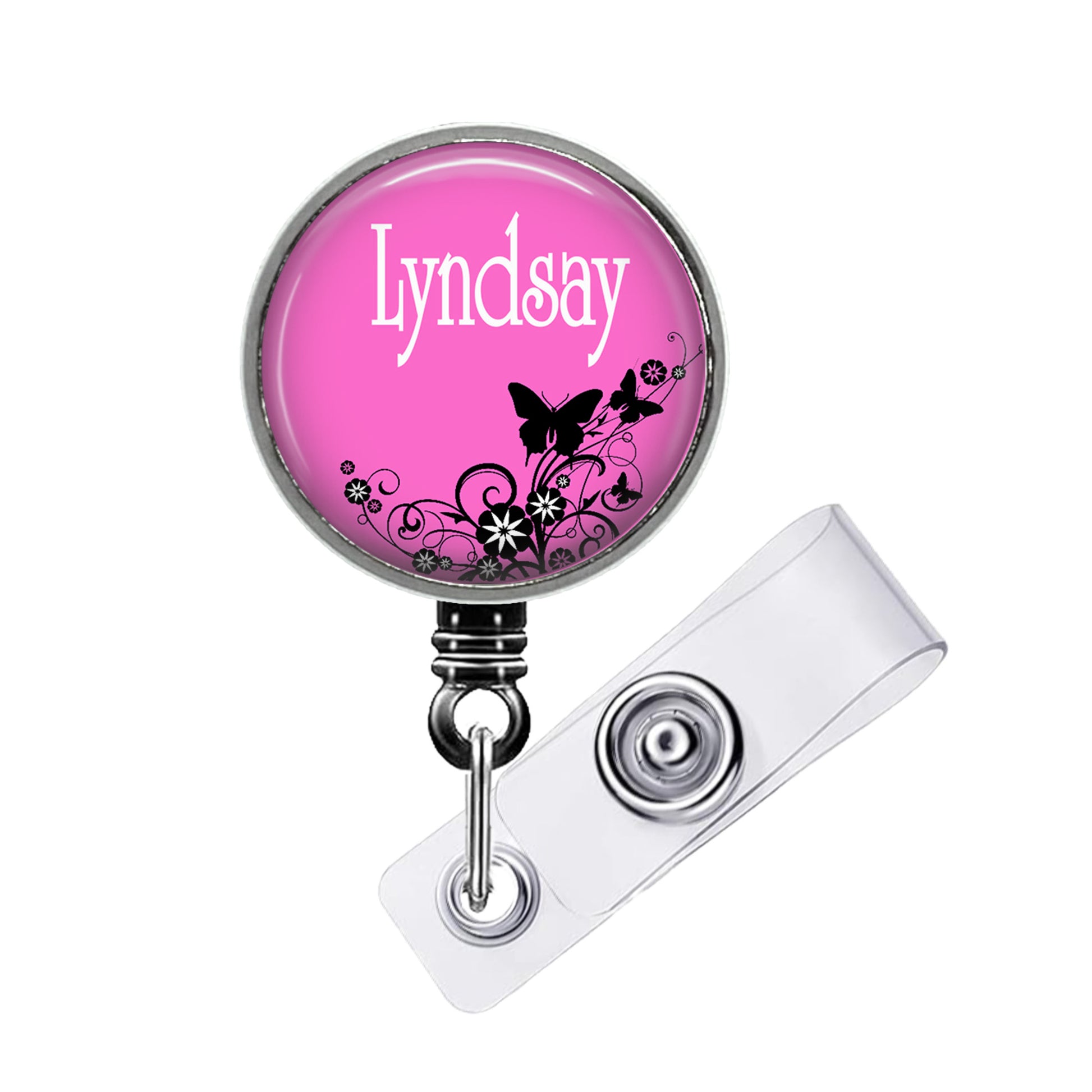 A pink badge with the name "Lyndsay" printed on it, featuring a floral design with butterflies.