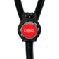 A red circular button with the name "Krisela" written on it, attached to a black strap or cord.