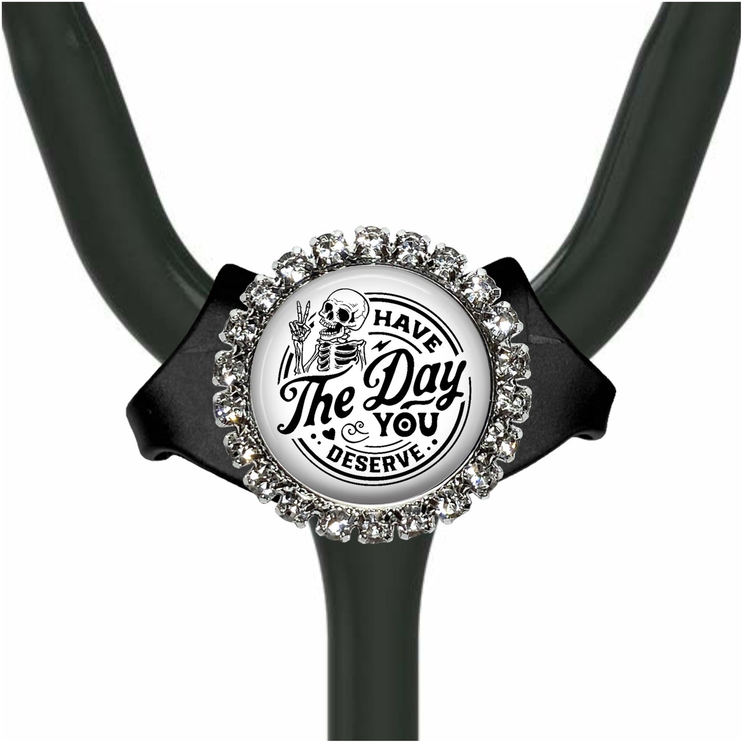 A black and white medical stethoscope with a decorative charm featuring a skeleton and the text "The Day You Deserve".