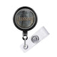 A black and silver badge holder with the name 'Jeanne' printed on it.