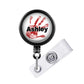 A black and white handprint badge holder with the name "Ashley" printed on it.