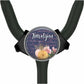 A round, black object with a floral design and the name "Karen" written on it.