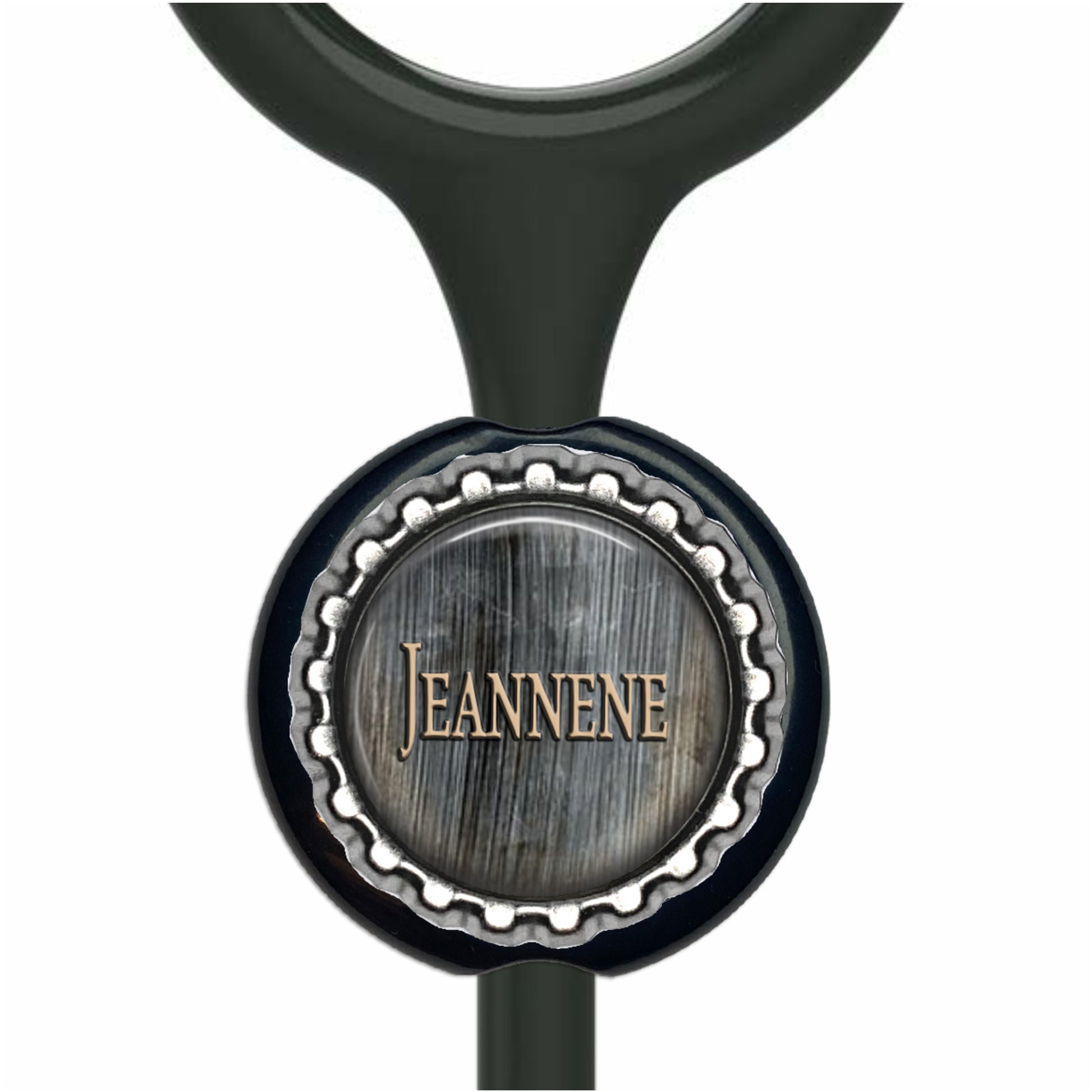 A black stethoscope with a silver cap-shaped charm featuring the name "Jeanne" engraved on it.