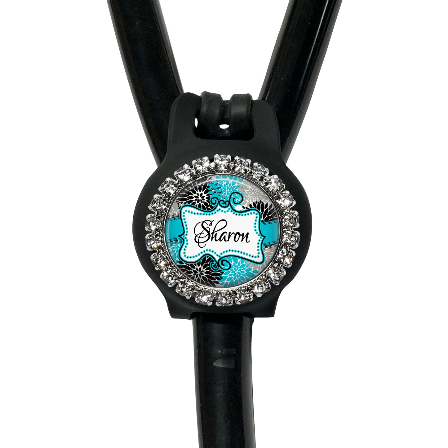 A black stethoscope with a personalized name badge attached to it.