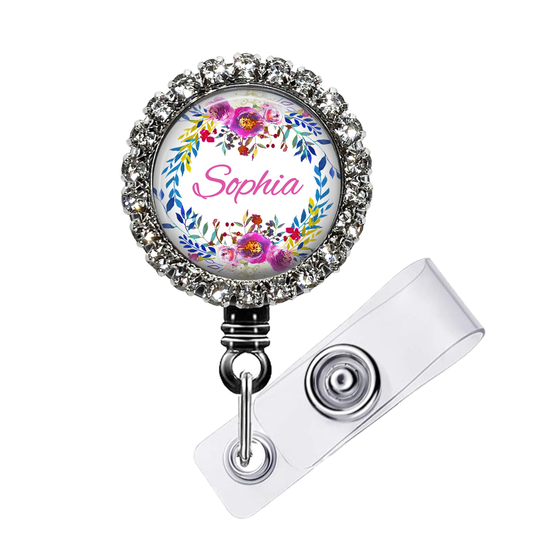 A personalized name badge with a floral design and the name "Sophia" printed on it. The badge is attached to a clear plastic holder with a metal clasp.