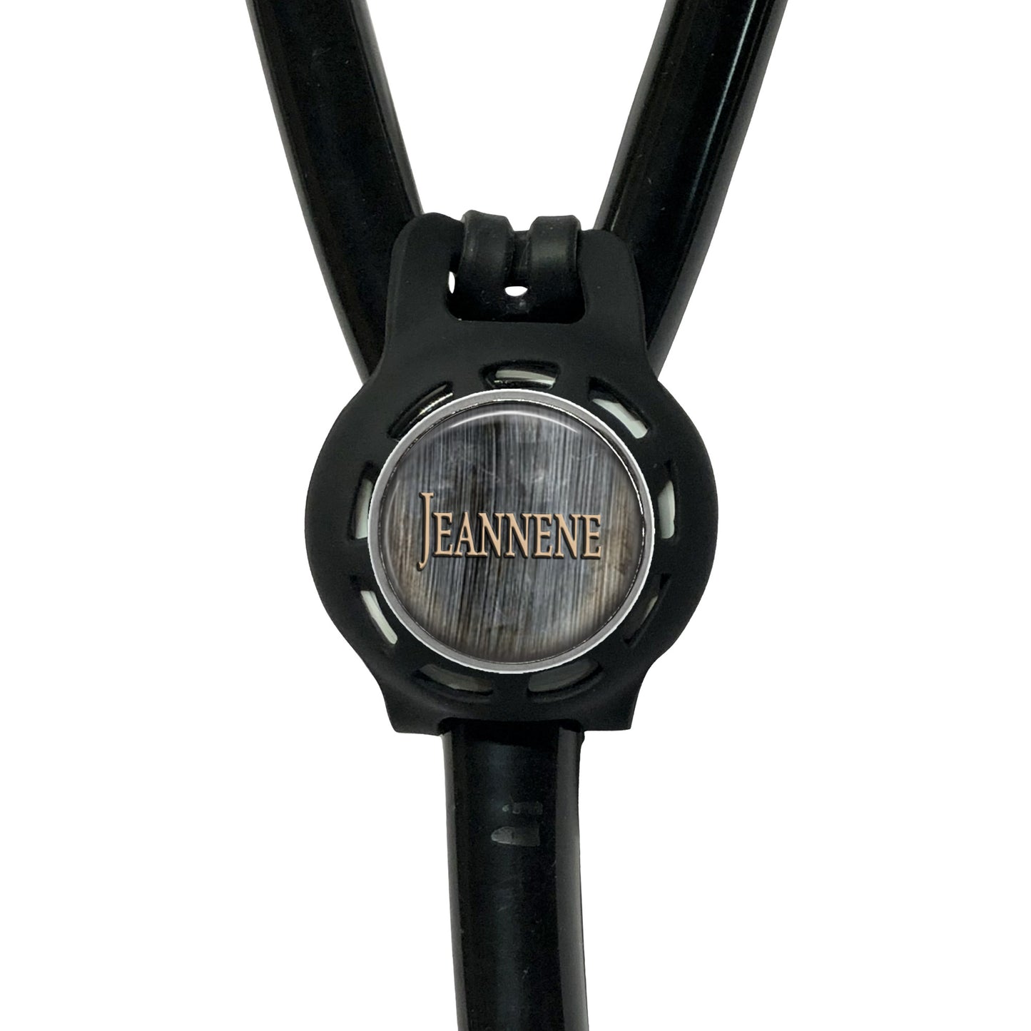 A black stethoscope with a circular logo on the diaphragm that says "Jeanne".