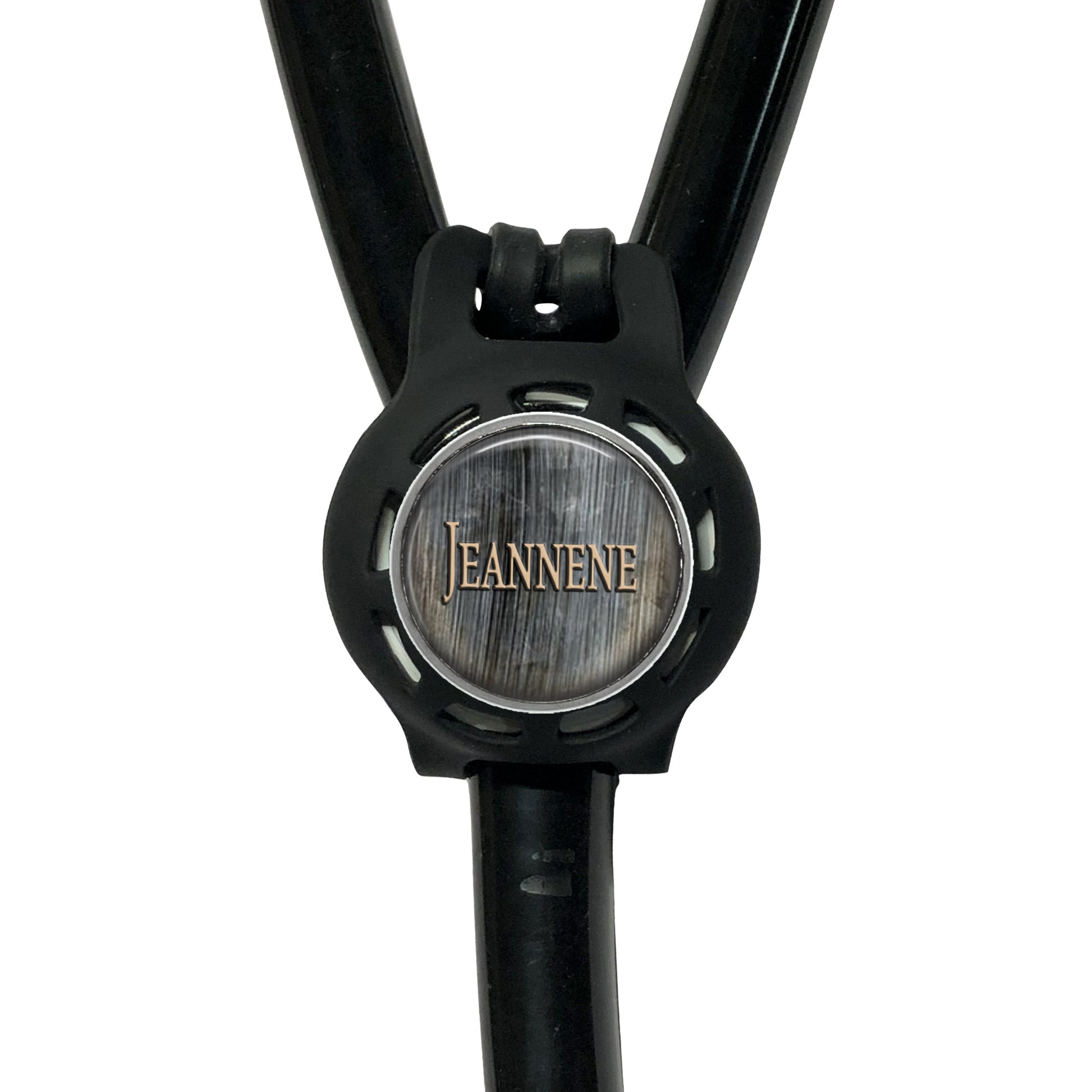 A black stethoscope with a circular logo on the diaphragm that says "Jeanne".