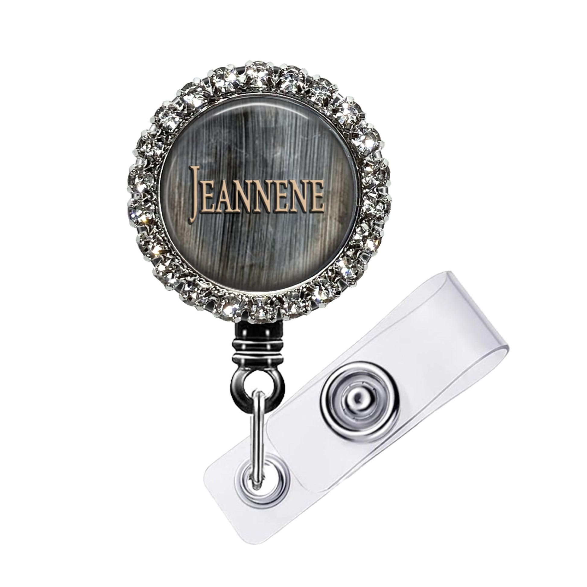 A personalized name badge with a silver and black design, featuring a name engraved on it. The name badge is adorned with a sparkling crystal or rhinestone embellishment.