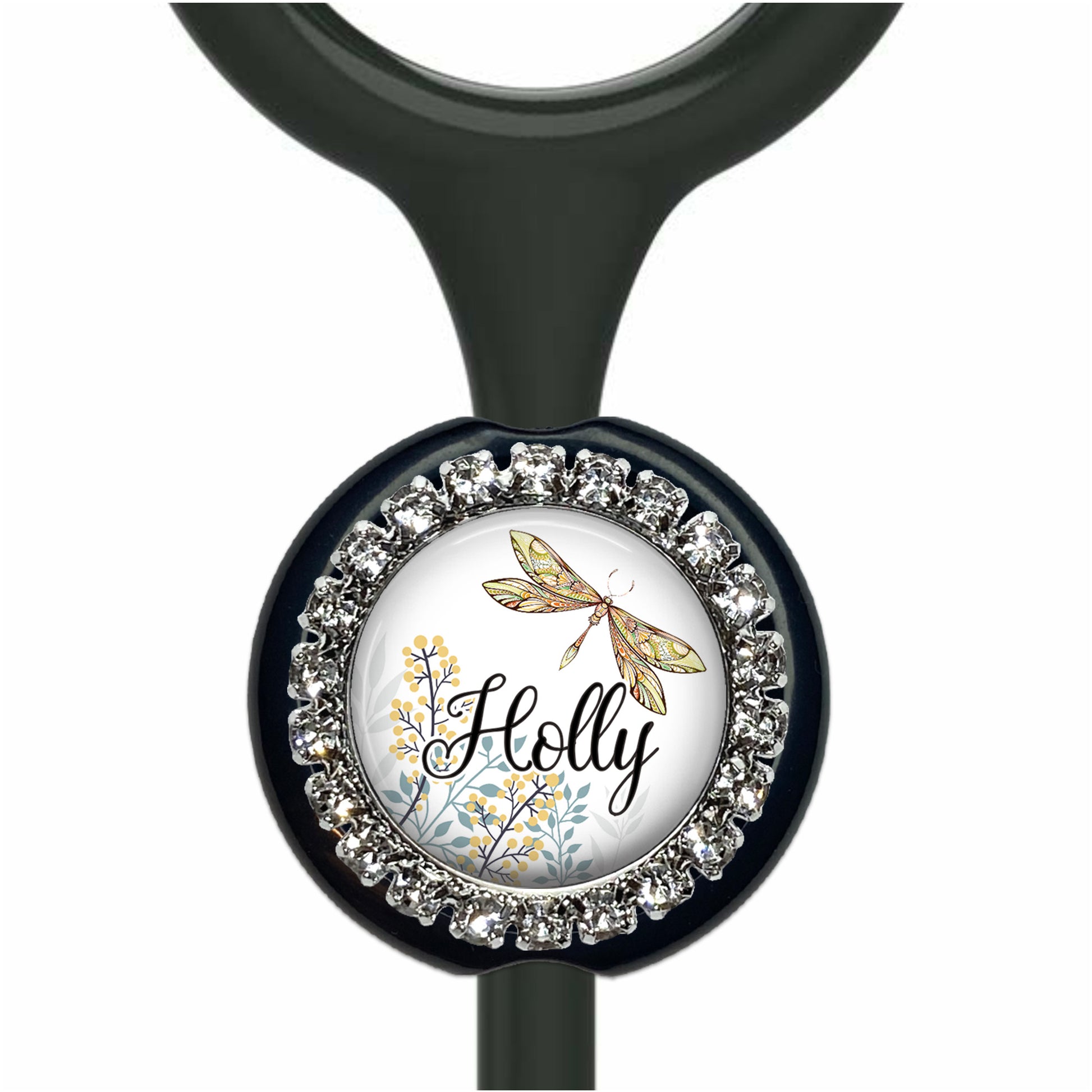 A black stethoscope with a round, decorative charm featuring a dragonfly and floral elements.