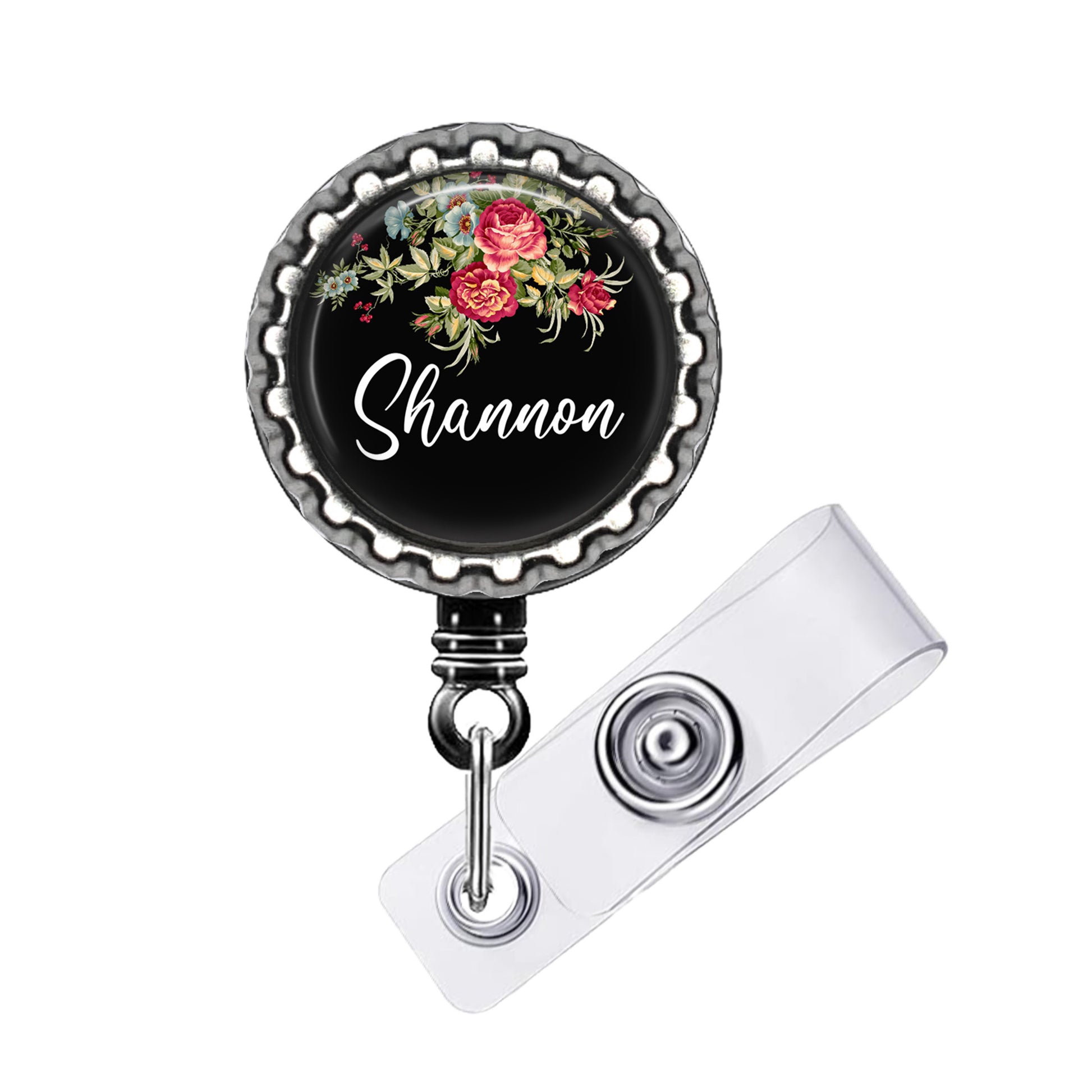 A black badge with a floral design and the name "Shannon" written on it.