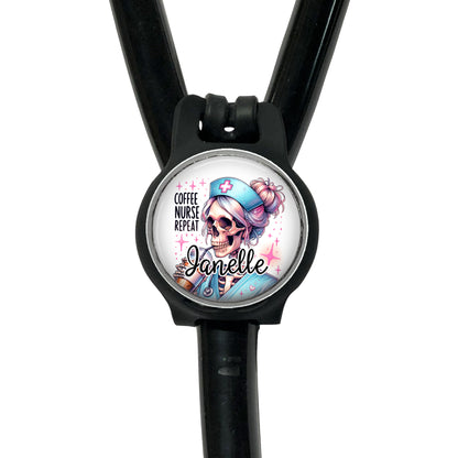 A black stethoscope with a round badge featuring a cartoon skeleton wearing a nurse's outfit and the text "Coffee nurse repeat Janelle".