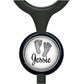 A black stethoscope with a round metal charm featuring a black and white image of a baby's foot and the name " Jessie" written below it.