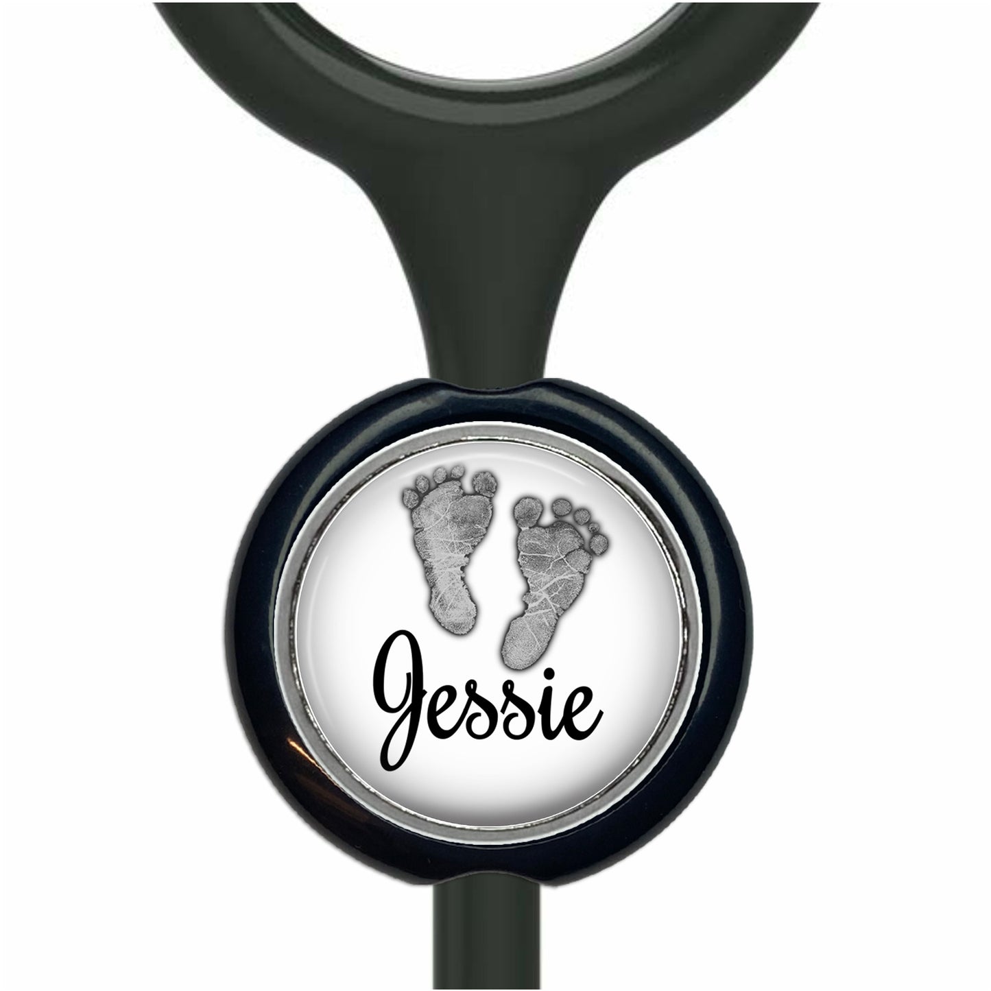 A black stethoscope with a round metal charm featuring a black and white image of a baby's foot and the name " Jessie" written below it.