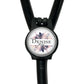 A black stethoscope with a round, personalized name badge attached to it.