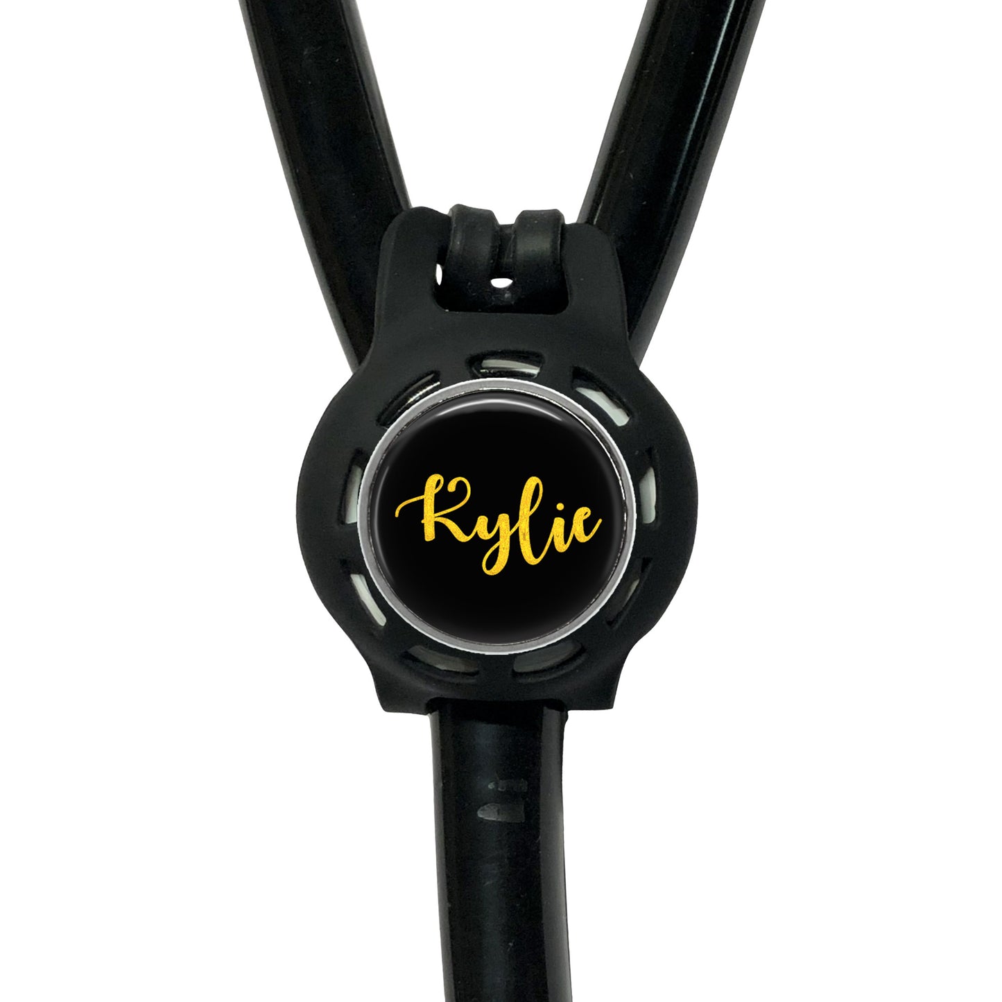 A black stethoscope with a round black button on the front, displaying the name " Kylie" in yellow cursive font.