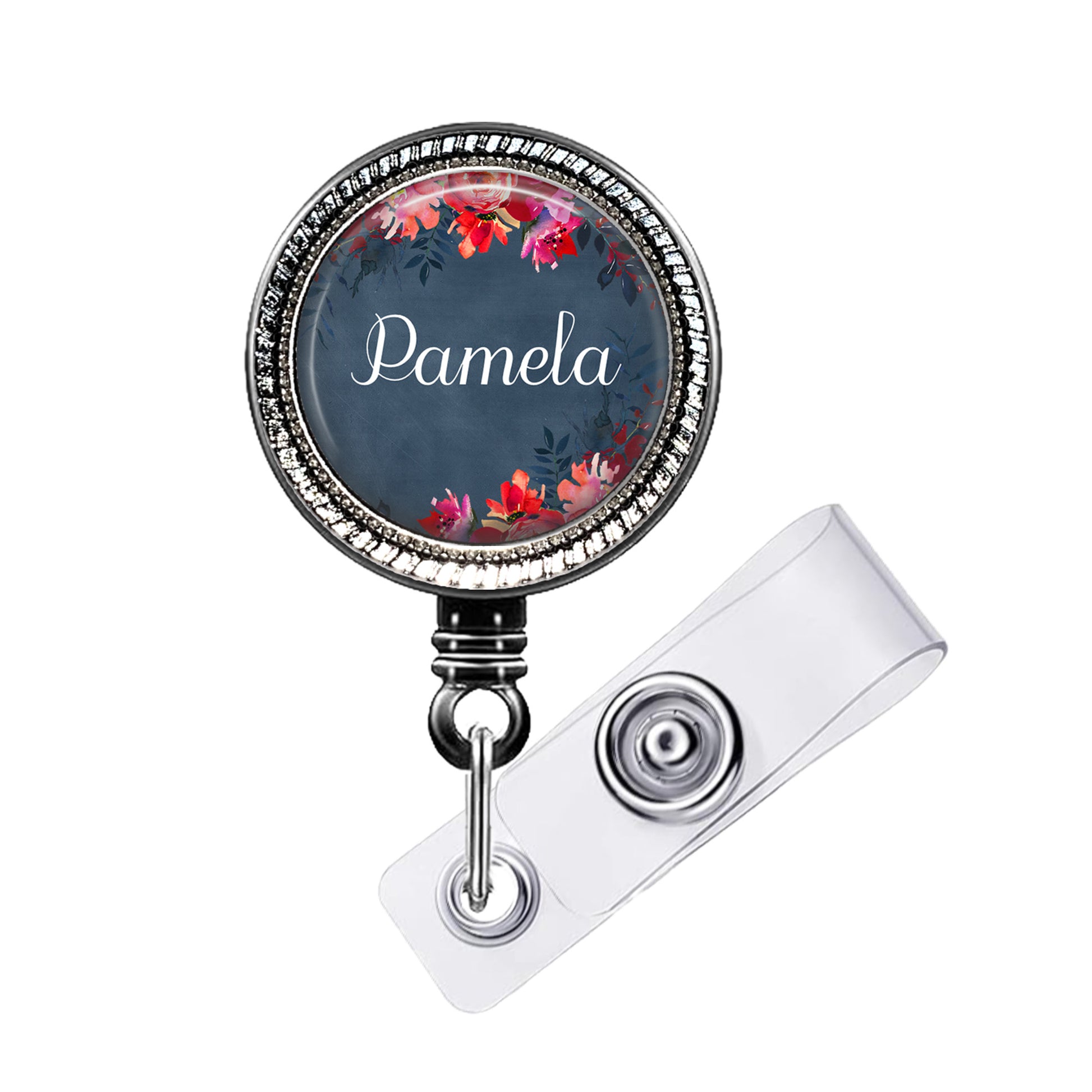 A round badge holder with a floral design and the name "Pamela" printed on it.