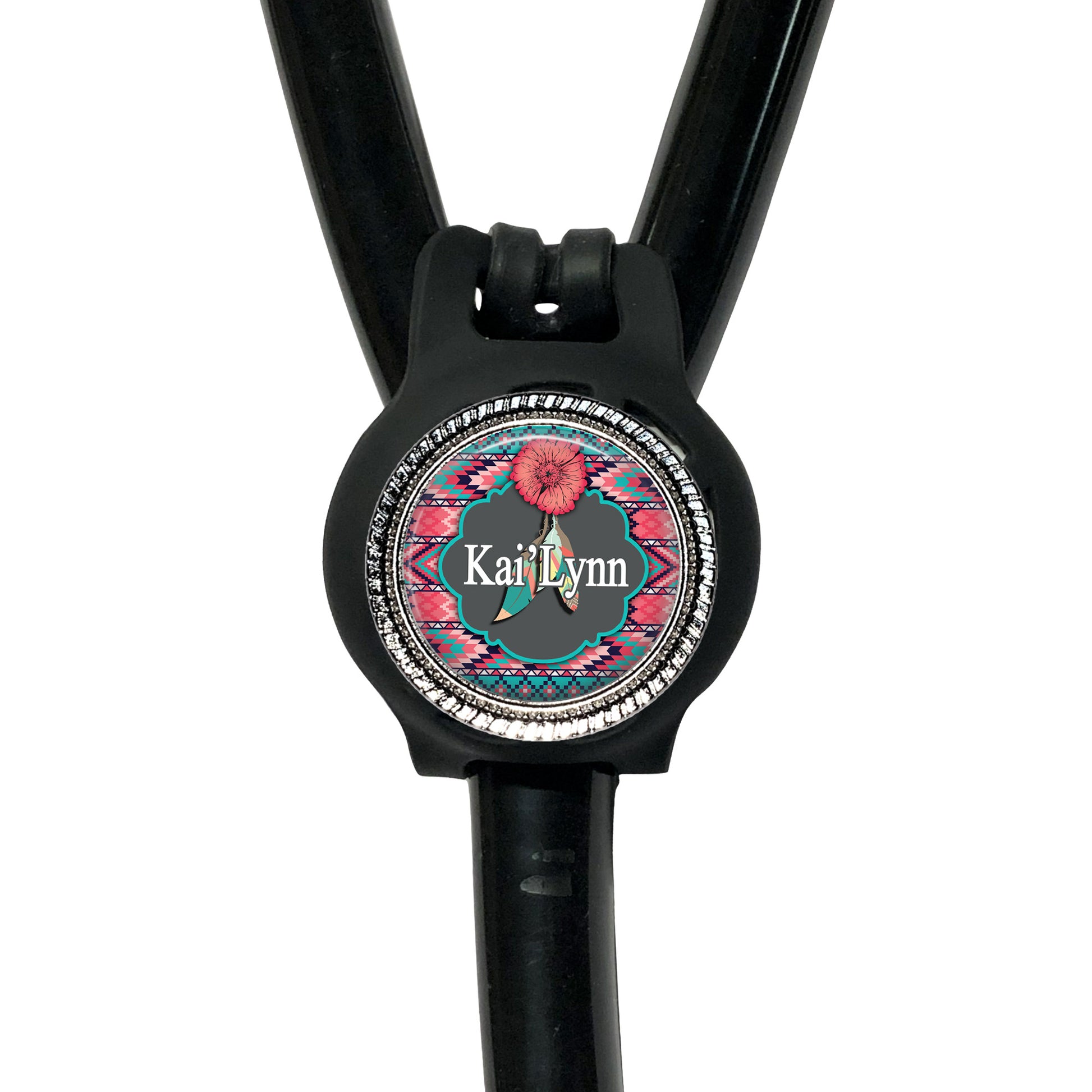 A black stethoscope with a personalized name badge attached to it.