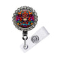 A colorful lanyard with a circular design featuring a skull and floral patterns. The lanyard is adorned with rhinestones and has a clear plastic clip.