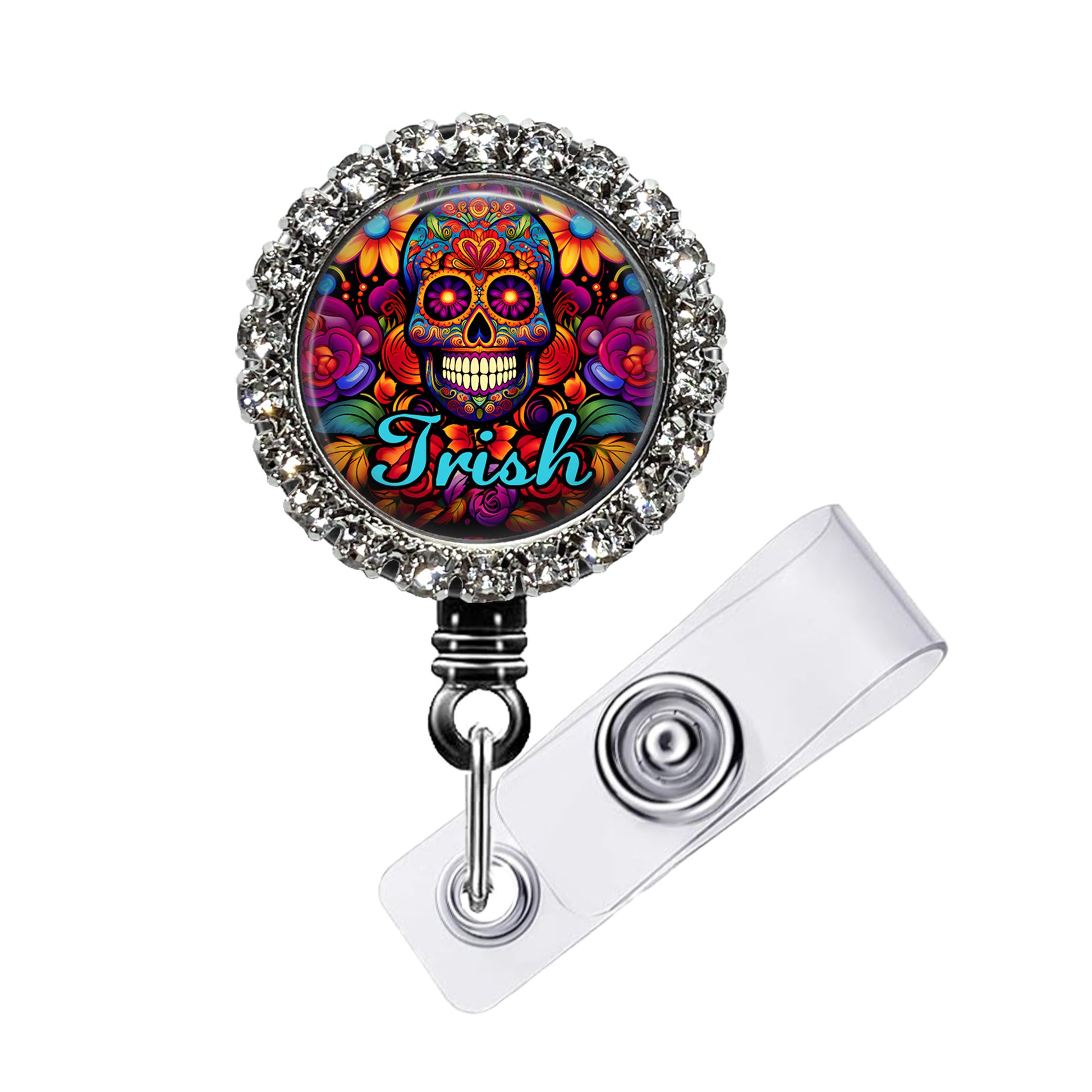 A colorful lanyard with a circular design featuring a skull and floral patterns. The lanyard is adorned with rhinestones and has a clear plastic clip.