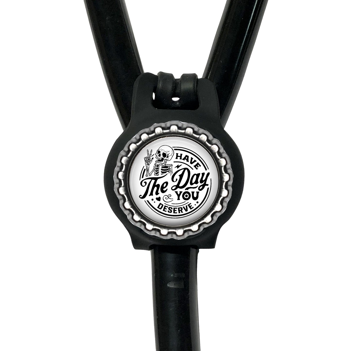 A black stethoscope with a silver cap-shaped charm featuring a skull and crossbones design and the text "The Day You Reserve".
