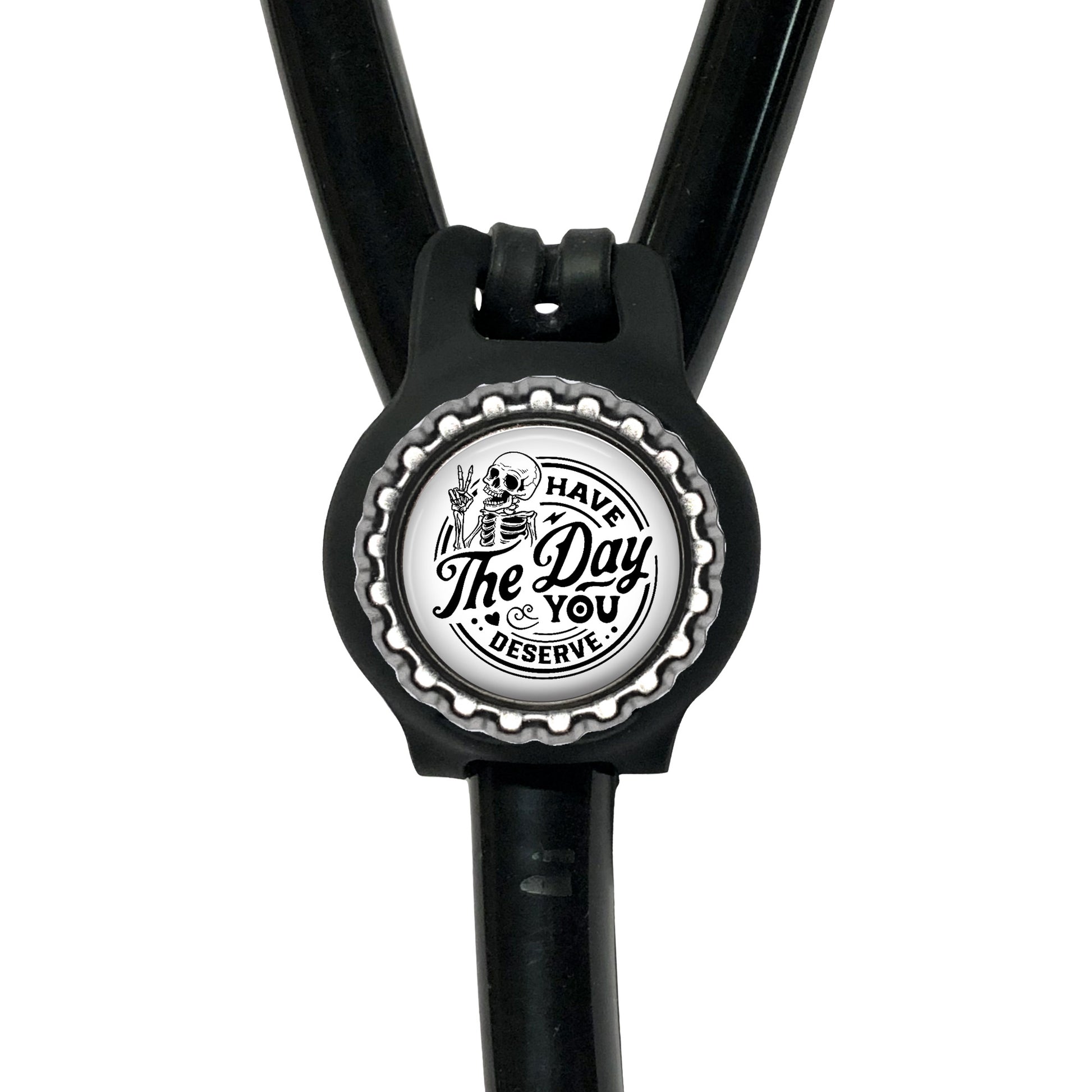 A black stethoscope with a silver cap-shaped charm featuring a skull and crossbones design and the text "The Day You Reserve".