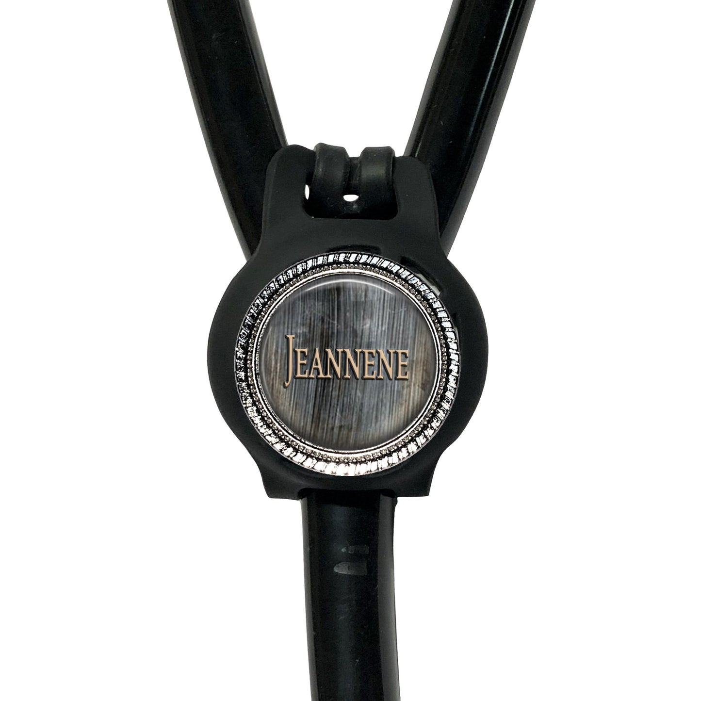 A black stethoscope with a silver circular badge on the handle.