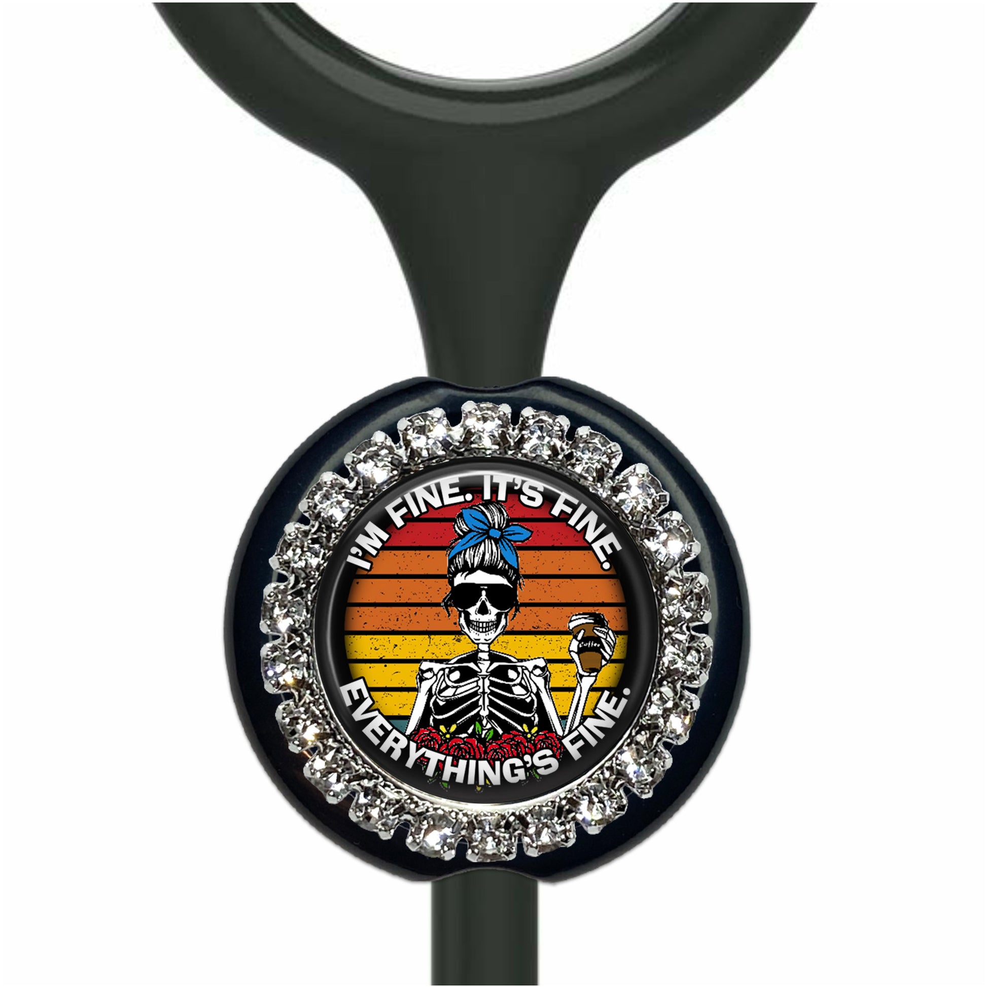 A black stethoscope with a decorative charm featuring a skeleton wearing sunglasses and holding a drink, surrounded by a sparkling crystal frame.