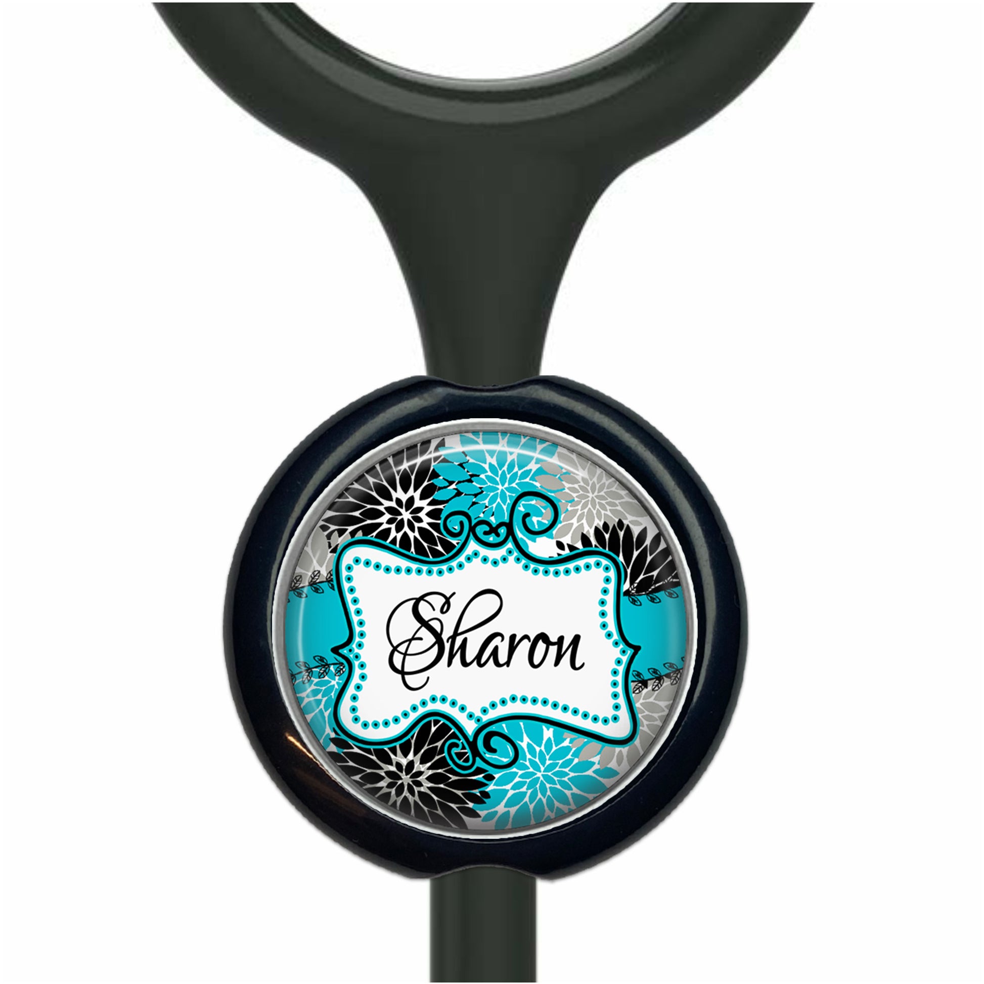 A black and blue decorative charm with the name "Sharon" written on it.