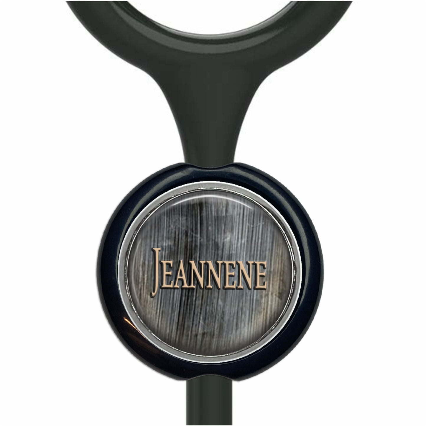A black stethoscope with a round metal badge featuring the name "Jeanne" printed on it.
